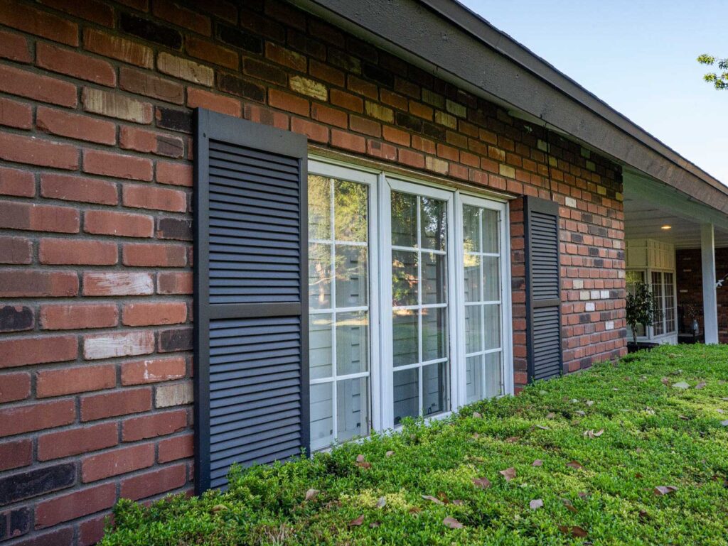 Repainted louvered shutters and window trim on a brick ranch home in North Central Phoenix